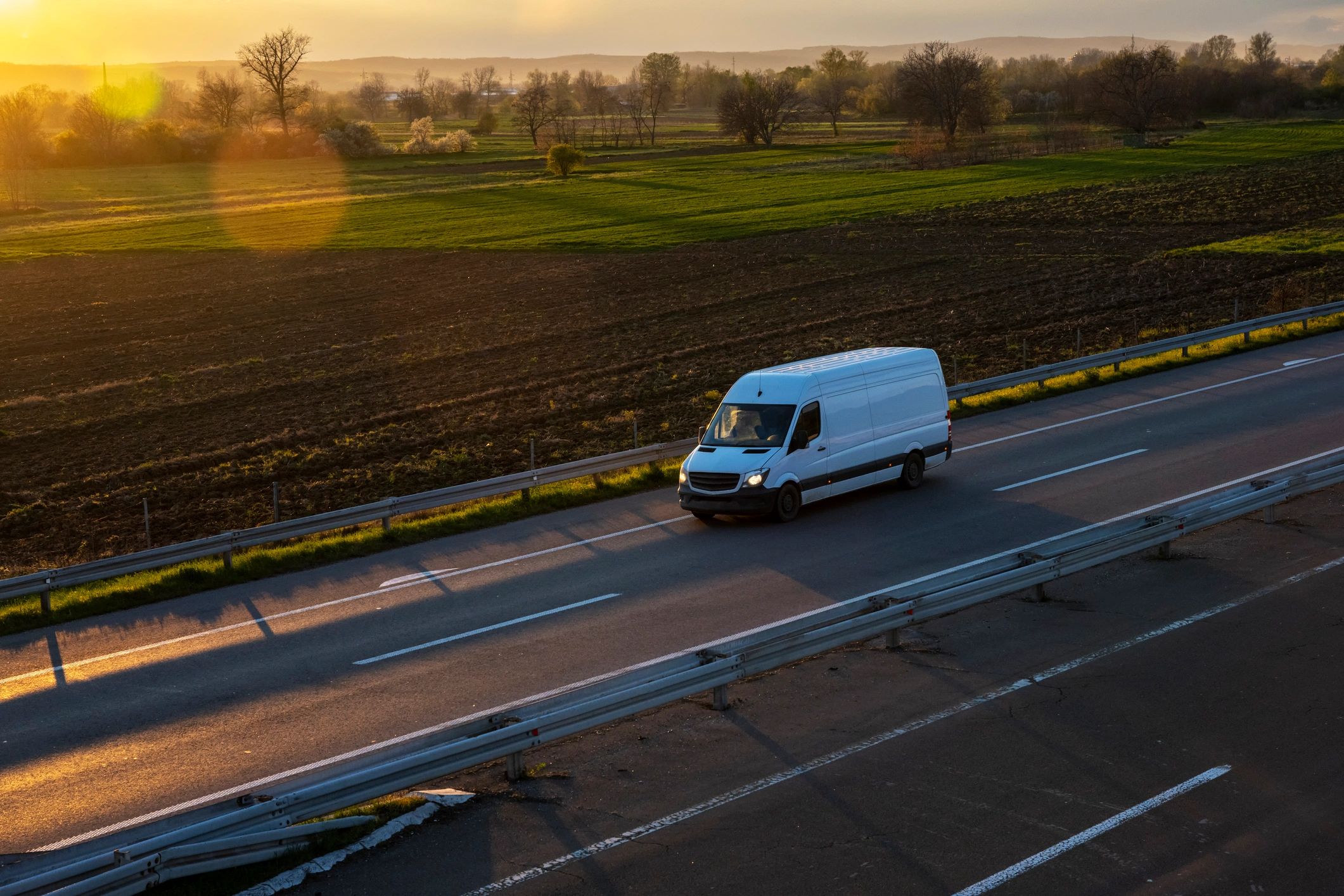 Blue delivery van on open highway